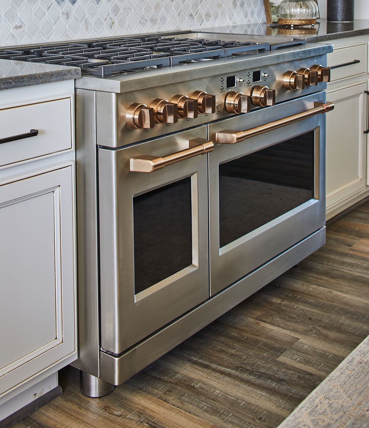 stainless steel double oven range with grey cabinets