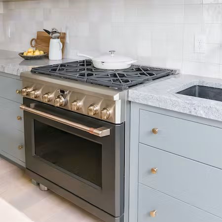 cafe matte black range in pale blue cabinets