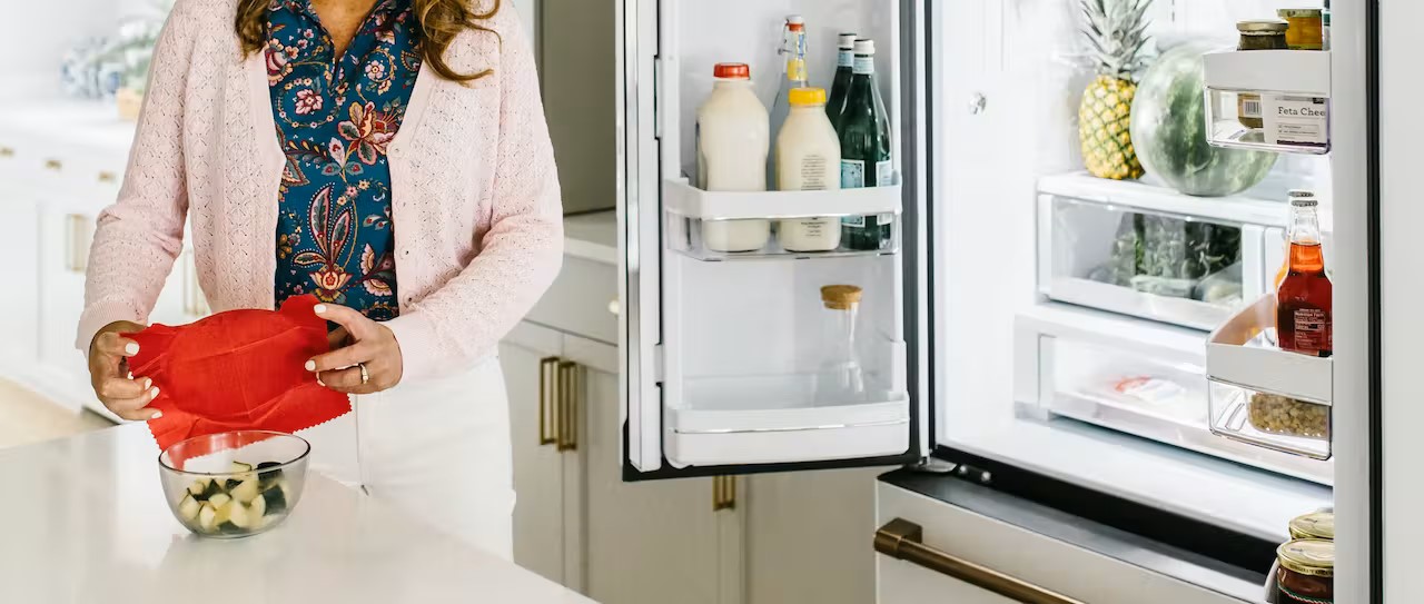 woman using wax cover for refrigerator storage